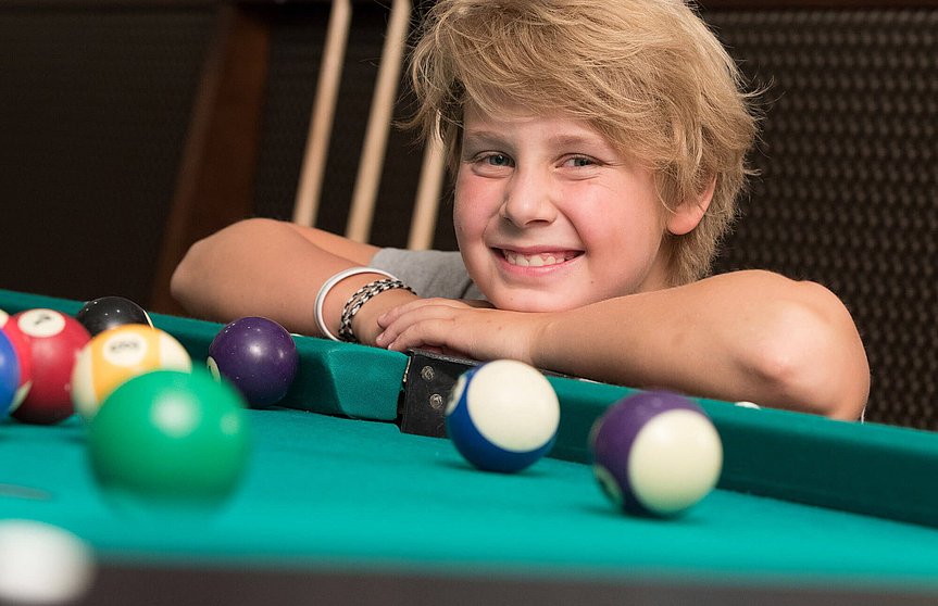 Kind am Billardtisch