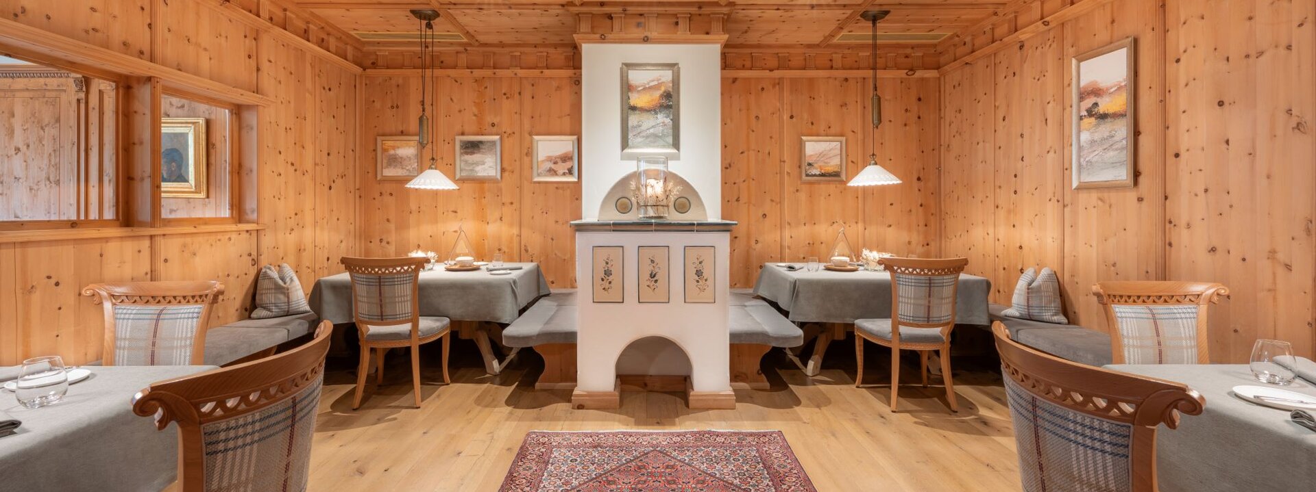 Der Innenraum eines stilvollen Restaurants, das mit warmem Holz und sanfter Beleuchtung eine einladende Atmosphäre schafft.