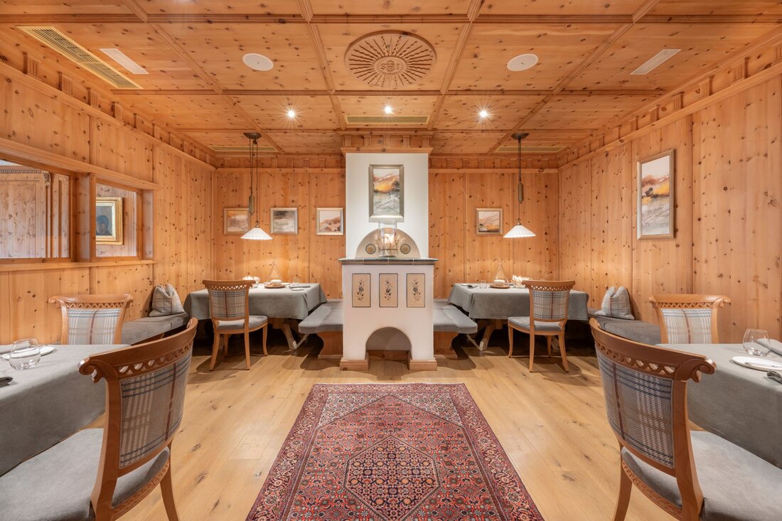 Der Innenraum eines stilvollen Restaurants, das mit warmem Holz und sanfter Beleuchtung eine einladende Atmosphäre schafft.
