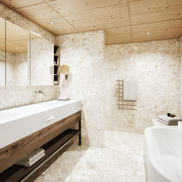 Ein modernes Badezimmer mit einer eleganten Badewanne und einem großen Waschbecken aus weißem Material, umgeben von Naturstein.