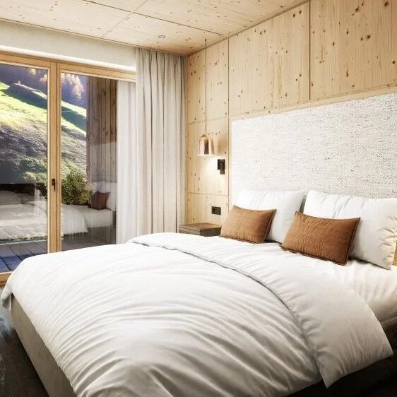 Ein modernes Schlafzimmer mit einem großen Bett, umgeben von warmen Holzwänden und sanften Beleuchtungselementen.