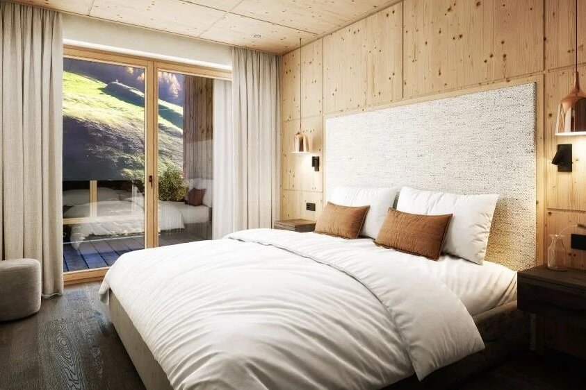 Ein modernes Schlafzimmer mit einem großen Bett, umgeben von warmen Holzwänden und sanften Beleuchtungselementen.