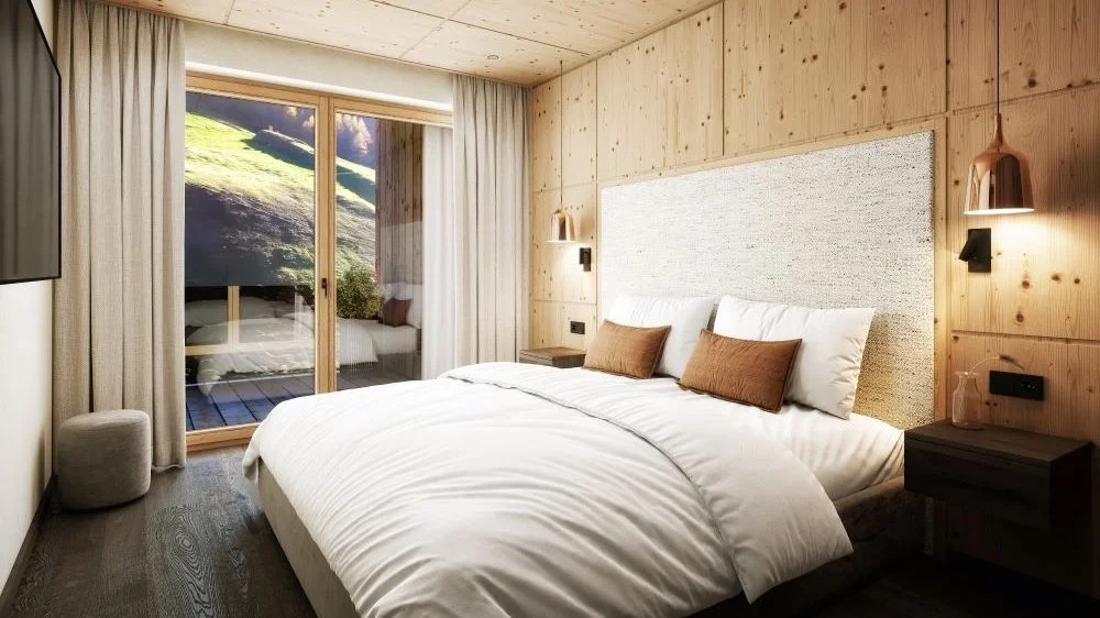 Ein modernes Schlafzimmer mit einem großen Bett, umgeben von warmen Holzwänden und sanften Beleuchtungselementen.